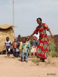 A kindergarten teacher and her students in Burkina Faso