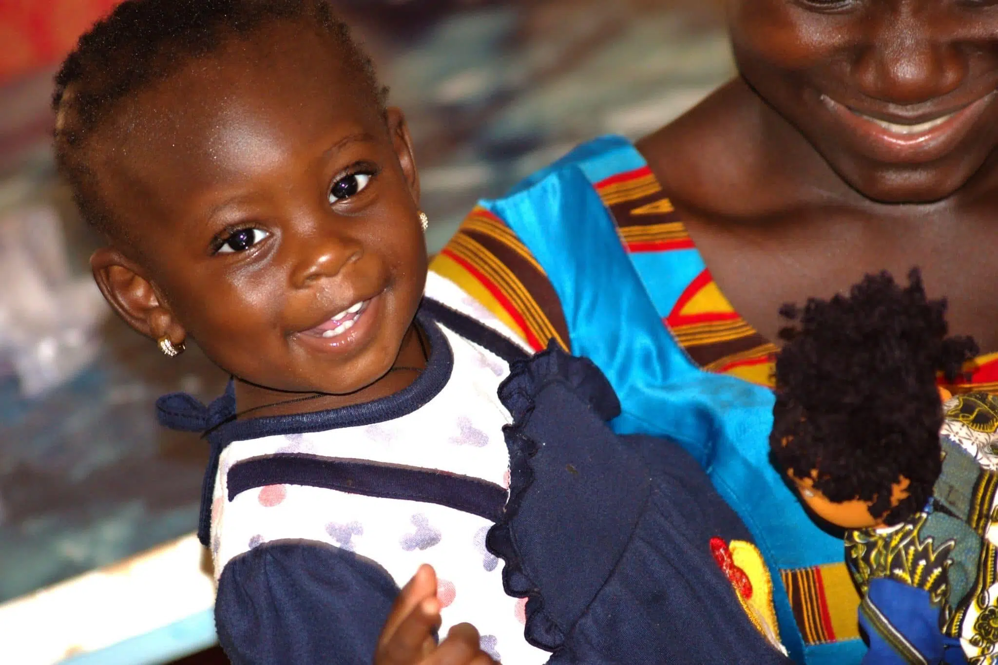 Little girl with a BiiBop doll in Burkina Faso