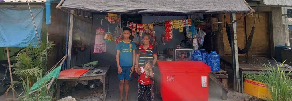A family in front of their small business, micro-business supported