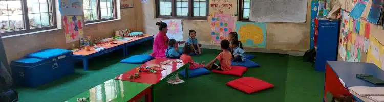 Anita in her classroom with students in Nepal